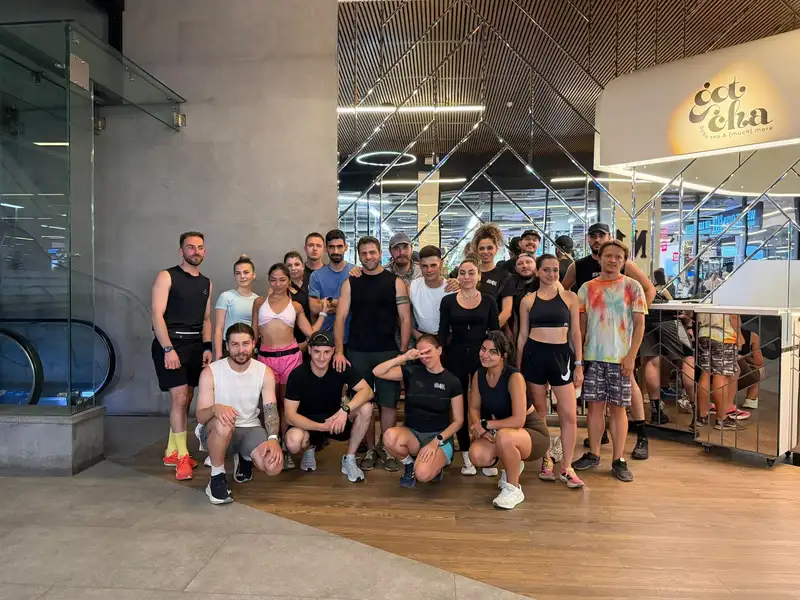 The club gathered together under a lit arcade after an evening run
