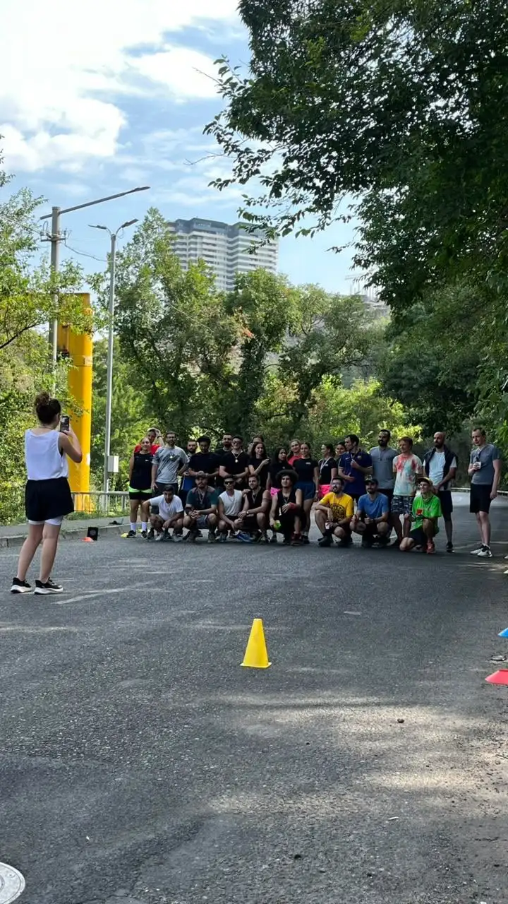 Runners lined up across a closed street at the start of a session