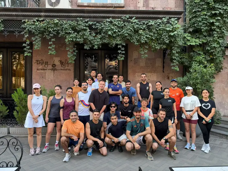 The group posing outside an ivy-covered stone building in Yerevan