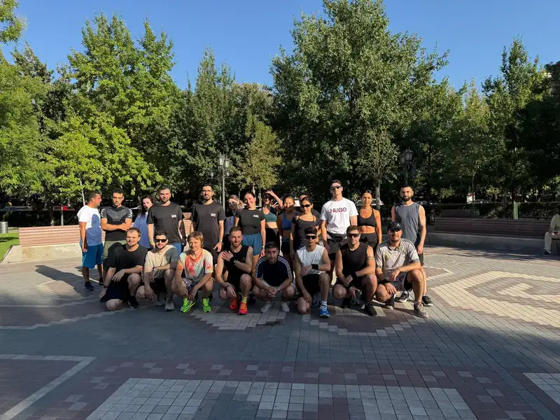 The group gathered on a tree-lined square after a morning run