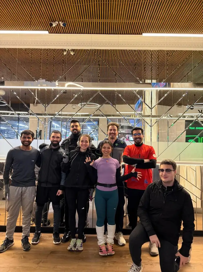 Runners posing together indoors in front of a window