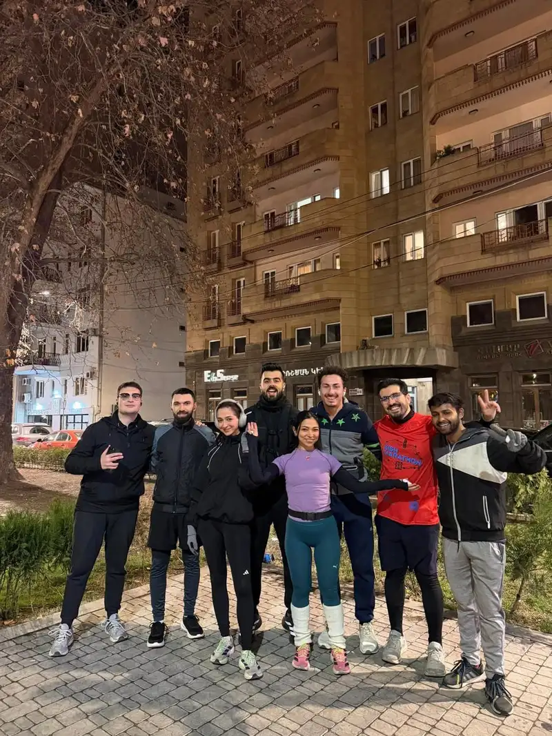An evening group photo in a courtyard between apartment blocks