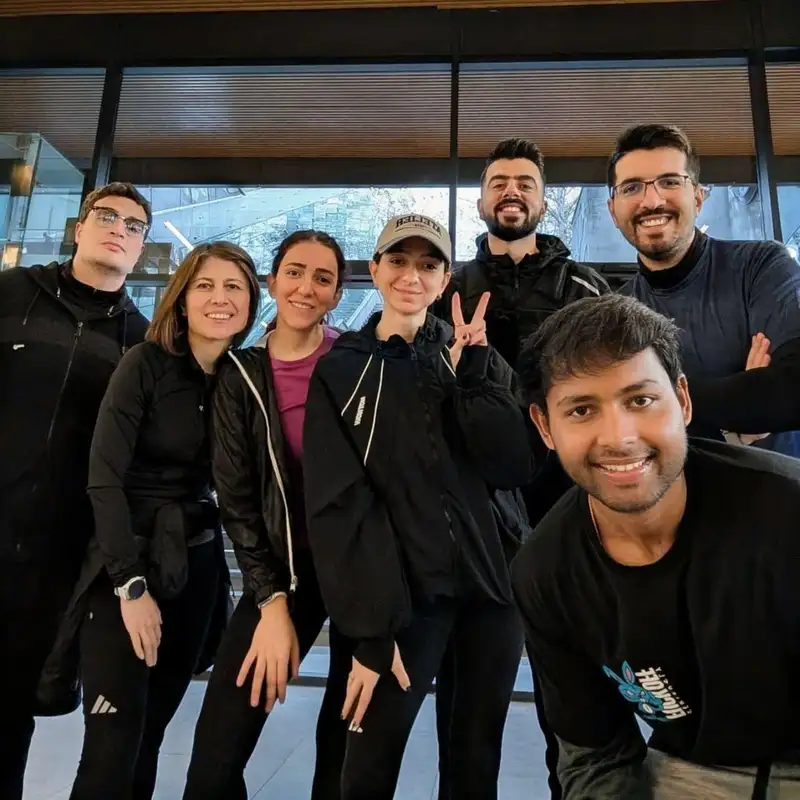 Runners crowding into a selfie in front of a window