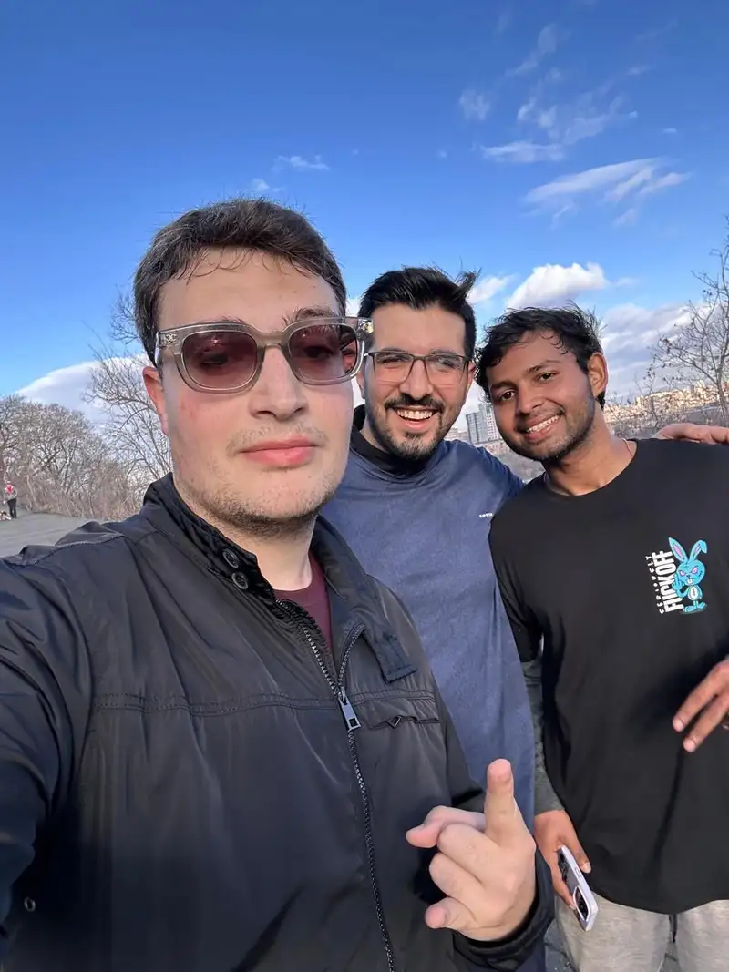 A selfie of three runners under a clear blue sky